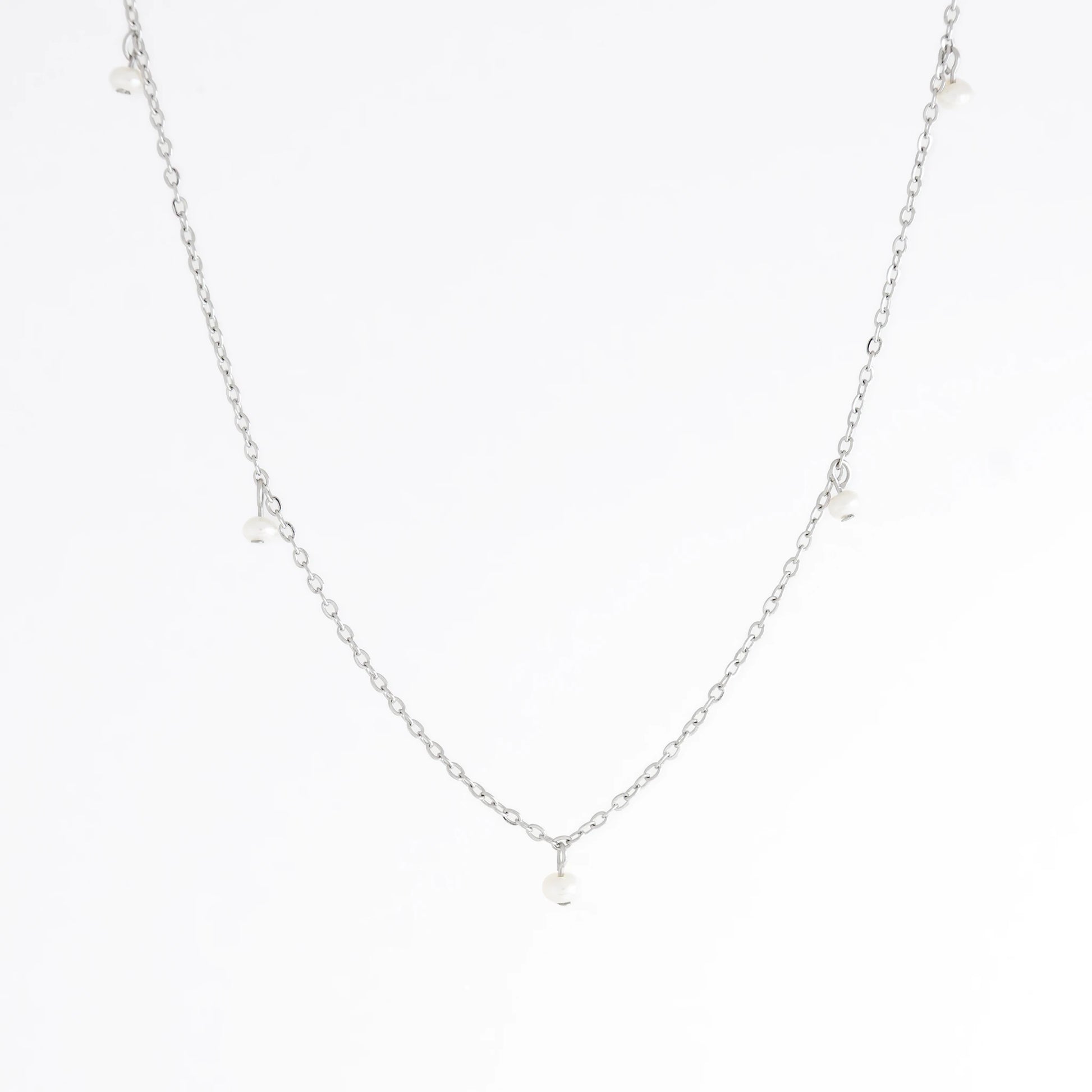 Silver necklace with a small pendant on a white background