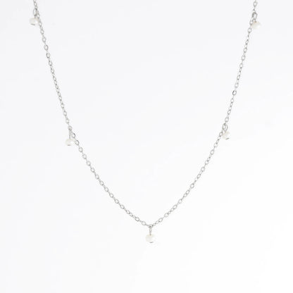 Silver necklace with a small pendant on a white background