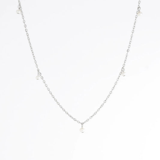 Silver necklace with a small pendant on a white background