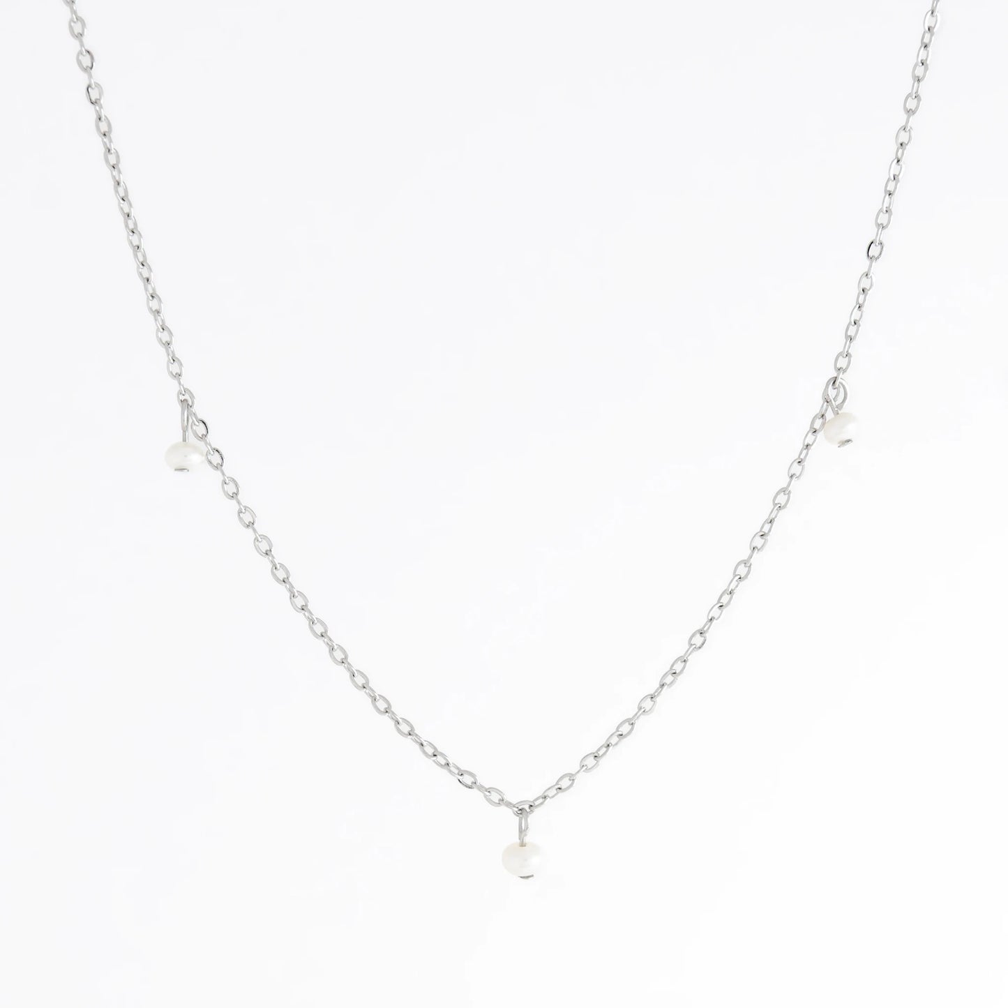 Silver necklace with a small pendant on a white background