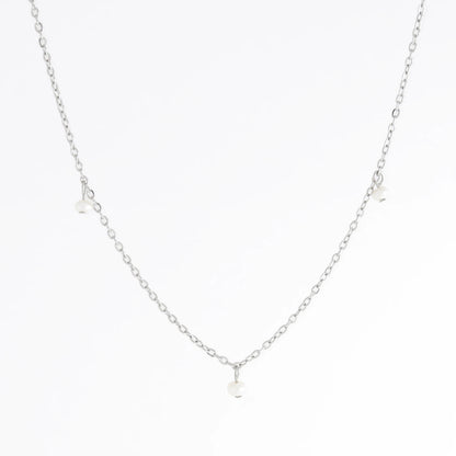 Silver necklace with a small pendant on a white background