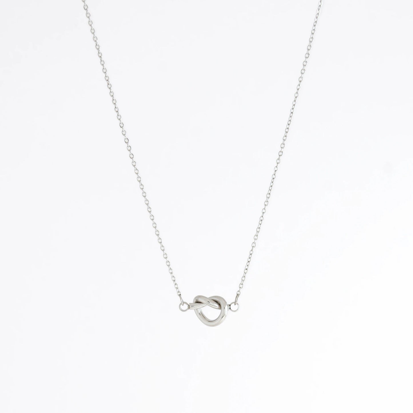 Silver necklace with a unique pendant design on a white background