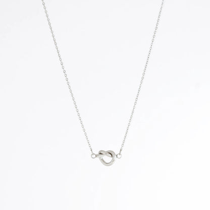 Silver necklace with a unique pendant design on a white background