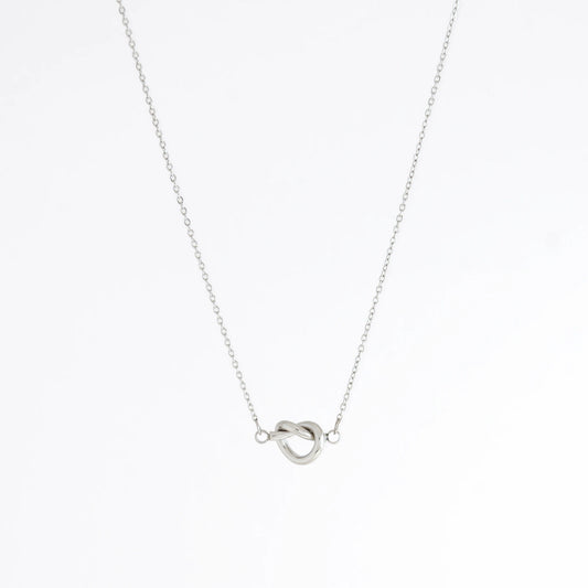 Silver necklace with a unique pendant design on a white background
