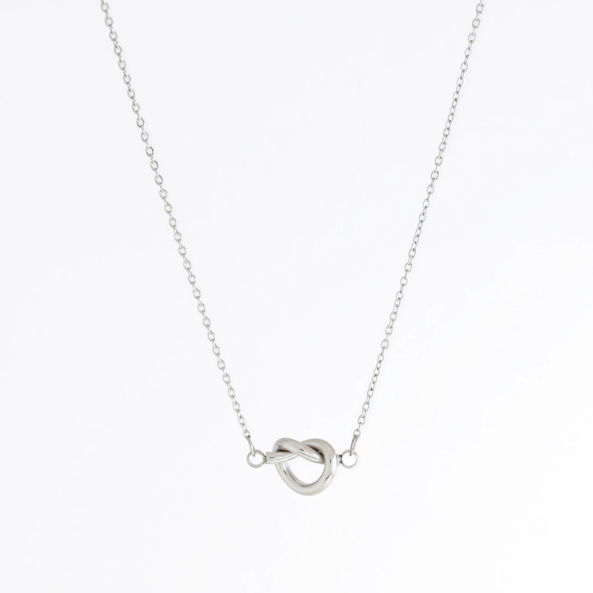 Silver necklace with a unique clasp design on a white background