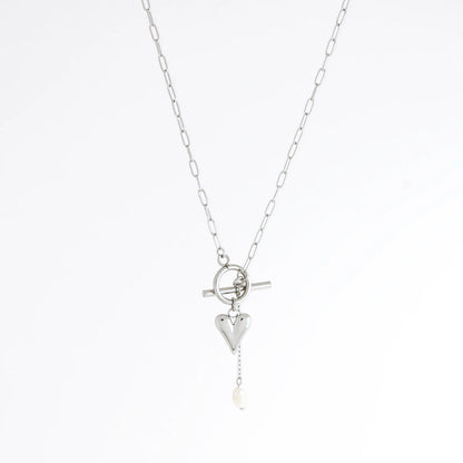 Silver necklace with heart and pearl pendant on a white background