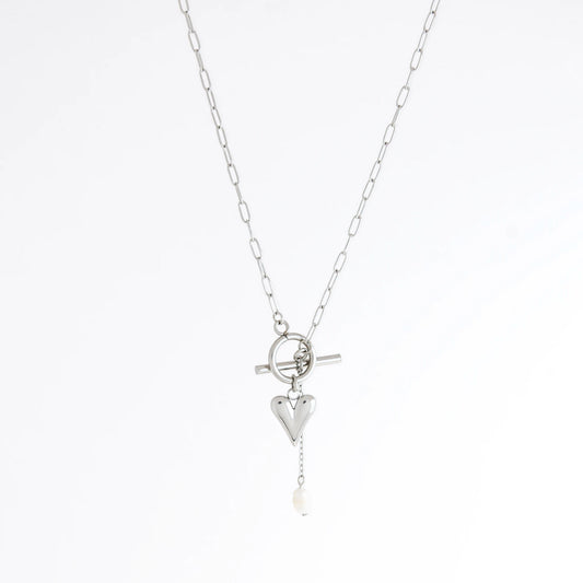 Silver necklace with heart and pearl pendant on a white background
