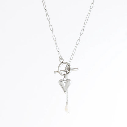 Silver necklace with heart and pearl pendant on a white background
