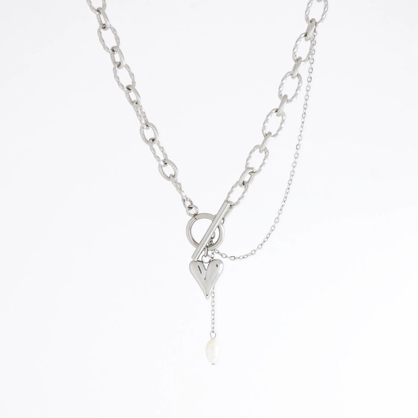 Silver paperclip necklace with a heart charm on a white background