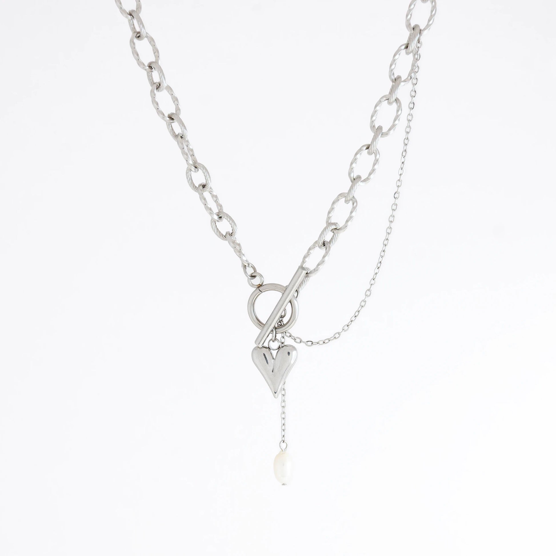 Silver paperclip necklace with a heart charm on a white background