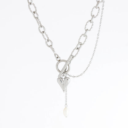 Silver paperclip necklace with heart and pearl pendant on a white background