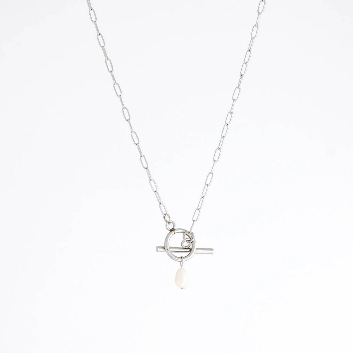 Silver necklace with a toggle clasp and pearl pendant on a white background