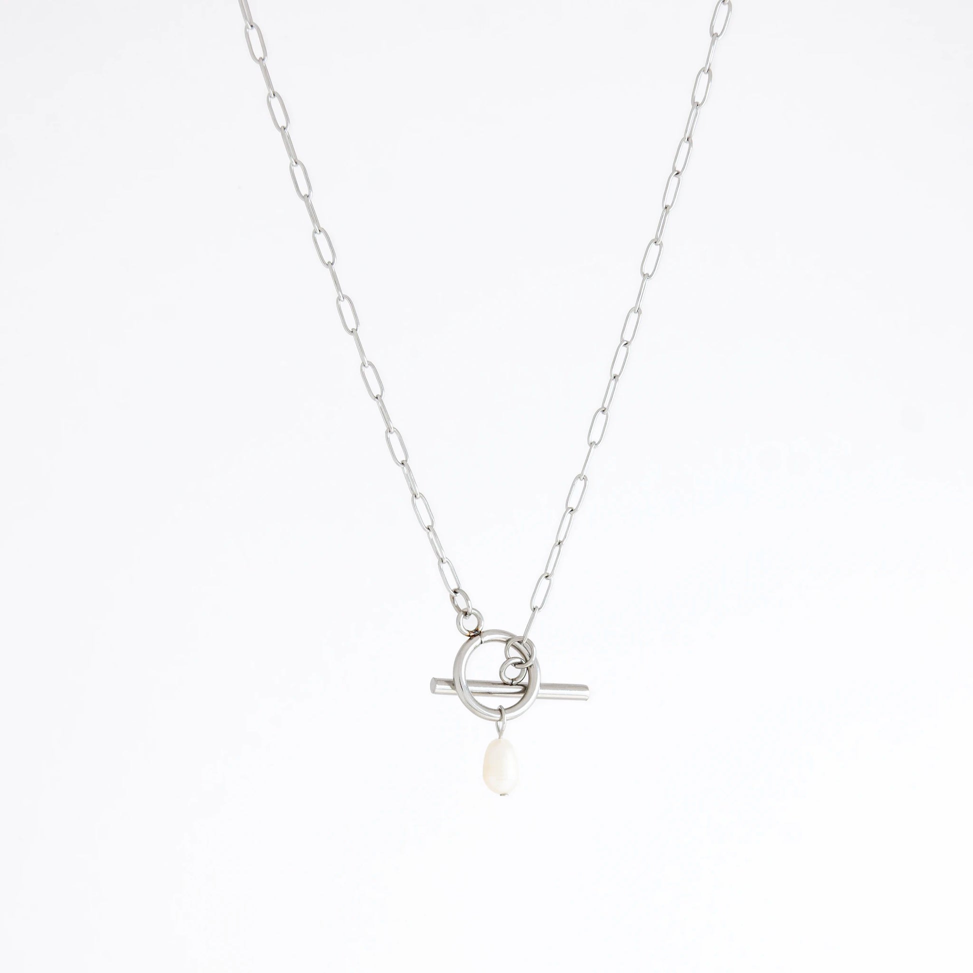 Silver necklace with a toggle clasp and pearl pendant on a white background