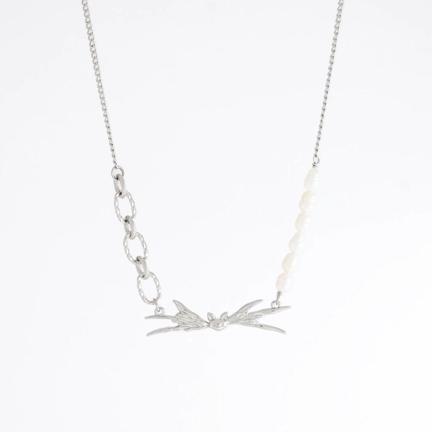 Silver necklace with leaf-like pendants on a white background