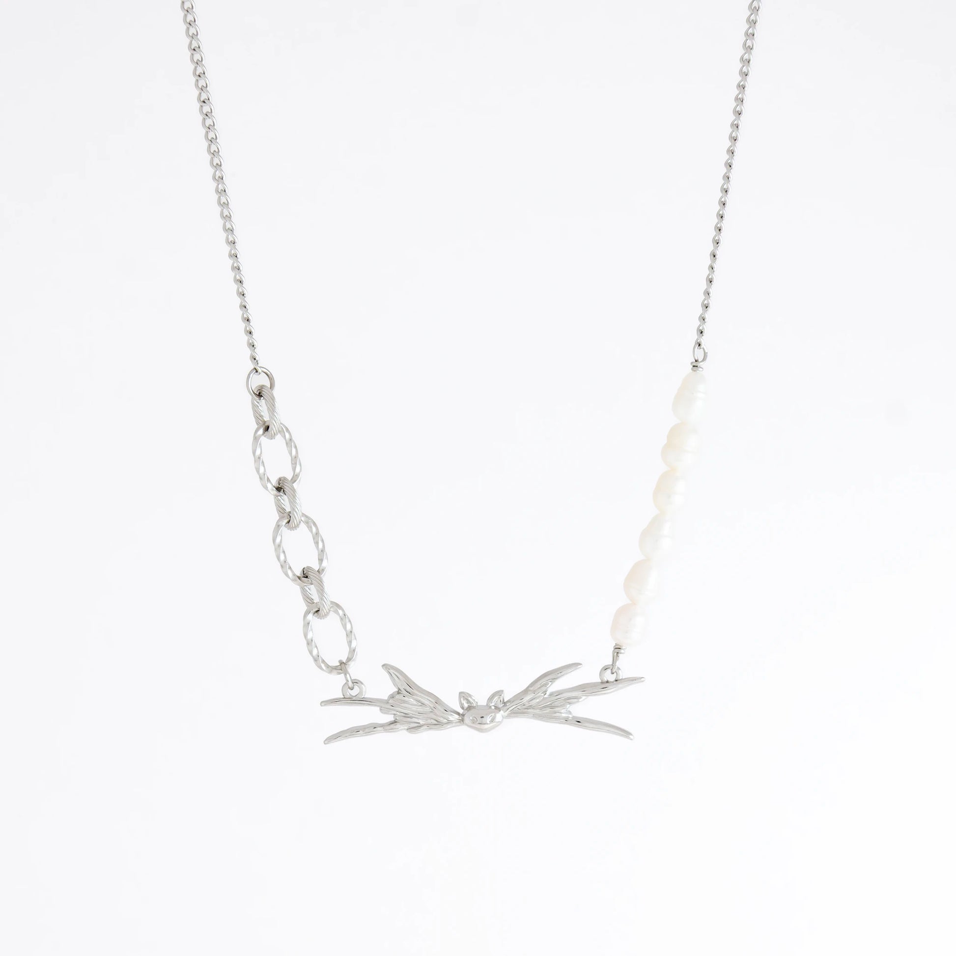 Silver necklace with leaf-like pendants on a white background