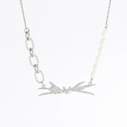 Silver necklace with leaf-like pendant on a white background