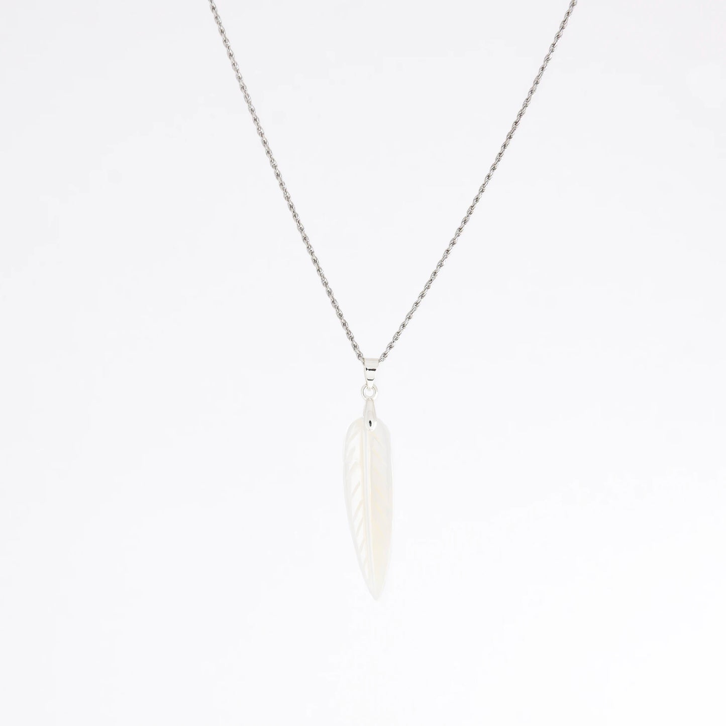 A delicate silver chain necklace featuring a small, stylized white feather pendant, shown against a plain white background.