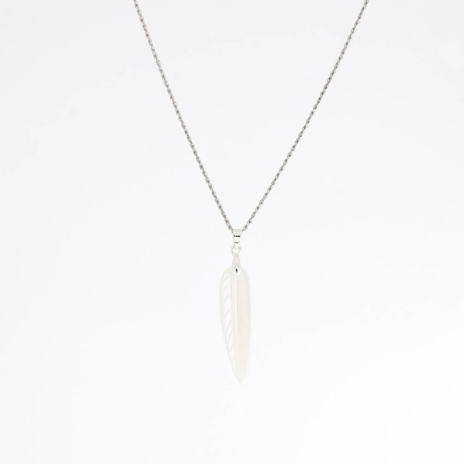 A delicate silver chain necklace featuring a small, stylized white feather pendant, shown against a plain white background.