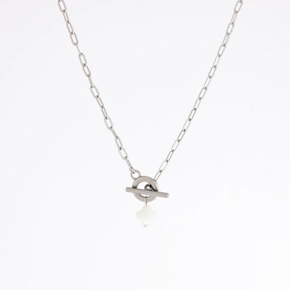 A silver chain necklace with a toggle ring pendant and a small white teardrop charm, shown against a plain white background.
