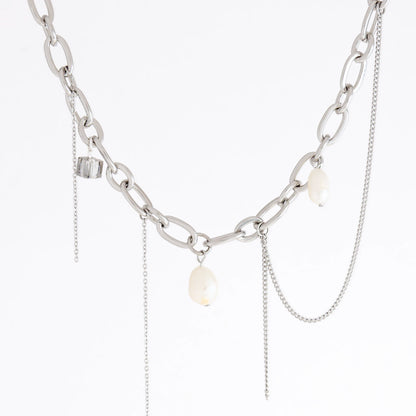 A silver-toned chain necklace featuring chunky oval links, delicate chain drapes, and three small white baroque pearl-like beads, shown against a plain white background.