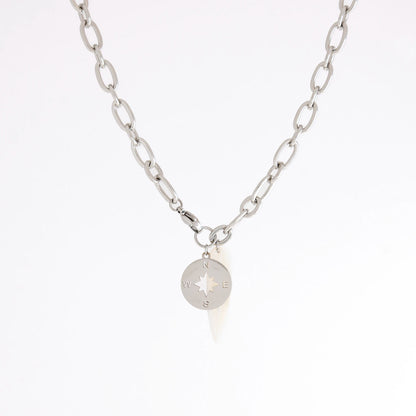 A silver chain necklace featuring a small circular compass pendant with cardinal directions, displayed against a clean white background.