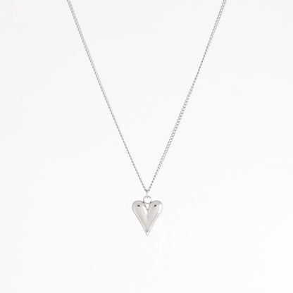 A silver heart pendant necklace on a delicate silver chain, photographed against a clean white background.
