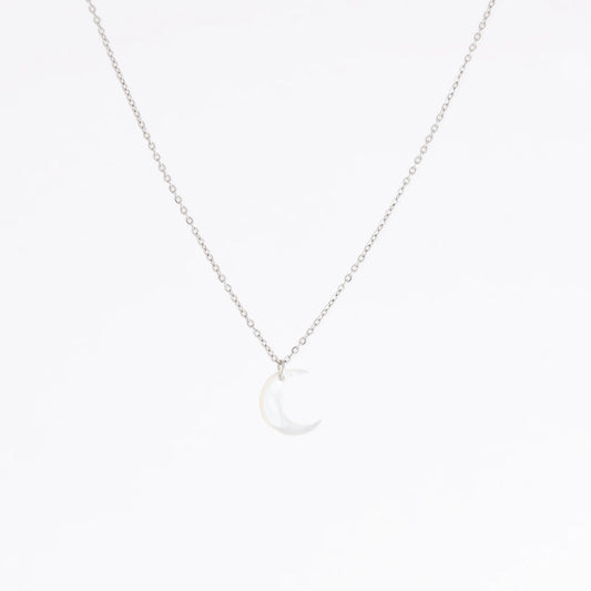 A delicate silver chain necklace featuring a small crescent moon pendant made of milky white mother-of-pearl, set against a seamless white background.