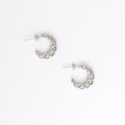 A pair of silver-toned twisted half-hoop earrings with post backs, displayed on a clean white background.