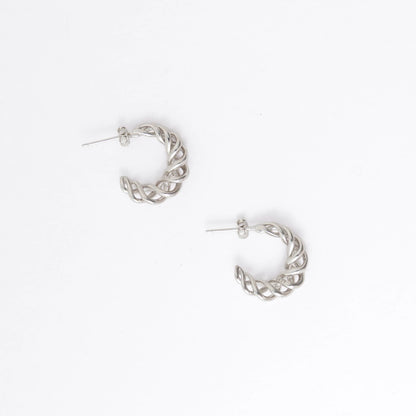 A pair of silver twisted half-hoop earrings on a clean white background.