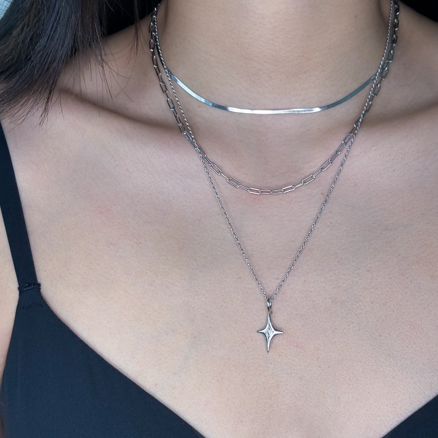 Silver rope chain with star charm worn on model