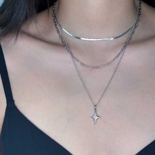 Silver rope chain with star charm worn on model