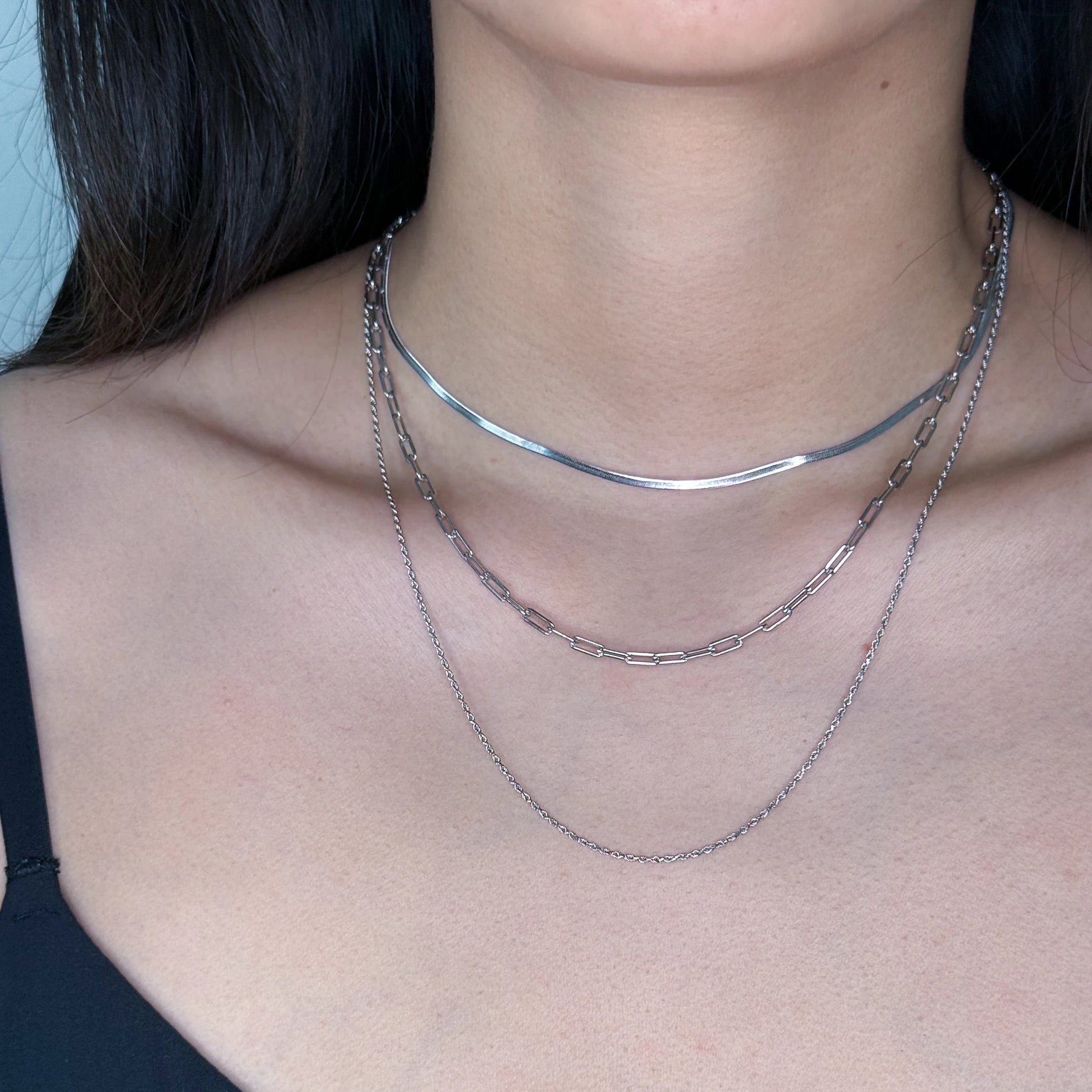 Silver layered chains worn on a model