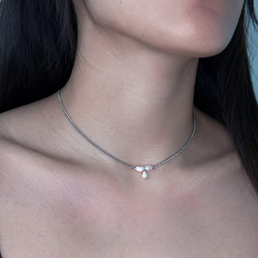Silver pearl choker necklace worn by a model