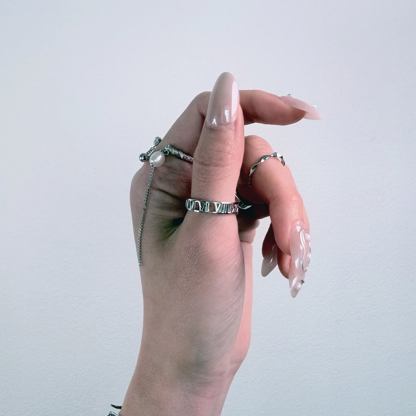 Sterling silver roman numeral ring on a gray background