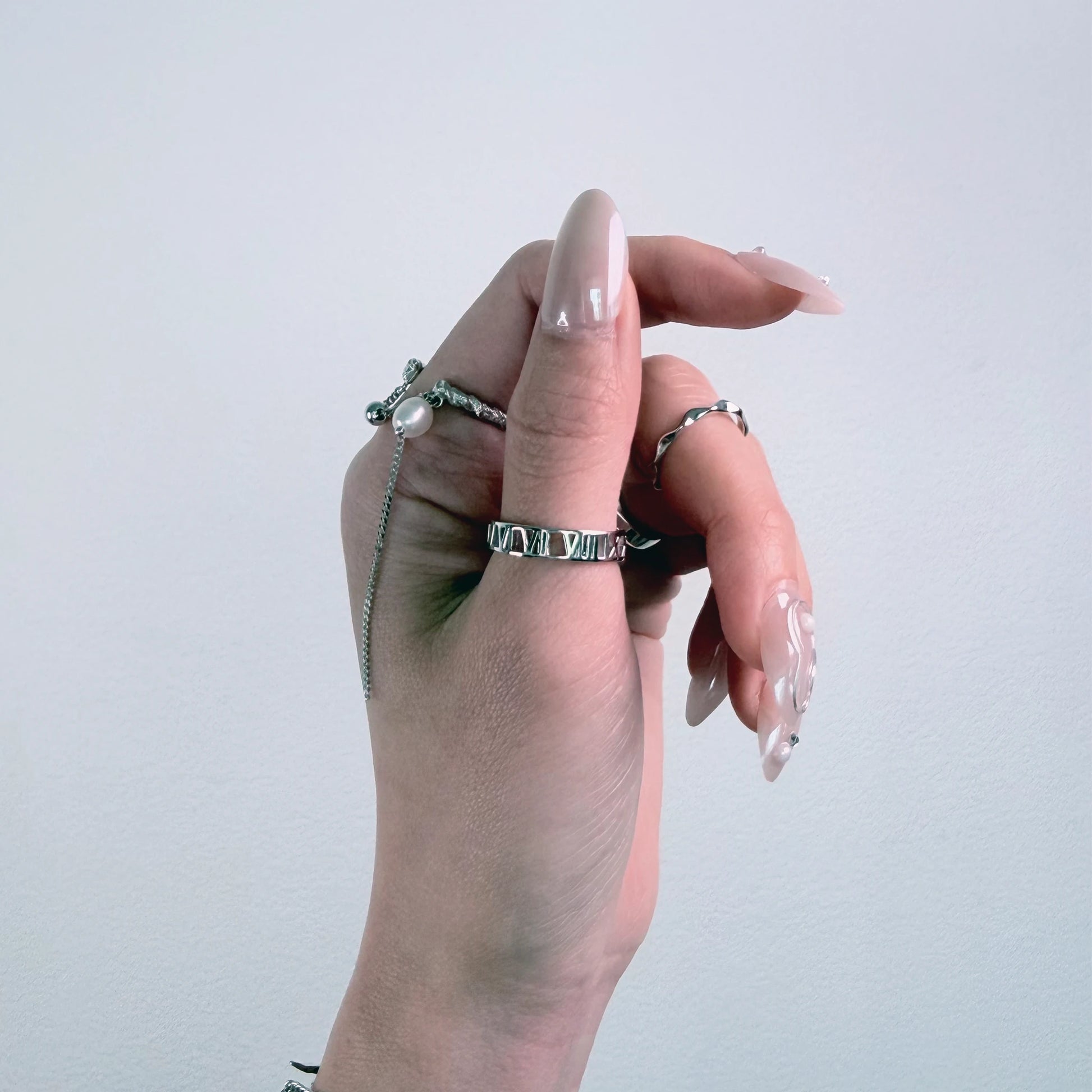 Sterling silver roman numeral ring on a gray background